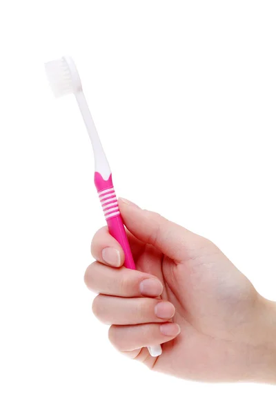 ピンクの歯ブラシを持っている手します。 — ストック写真