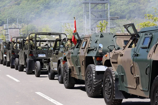 Japanese armored vehicle departs with soldier — Stock Photo, Image