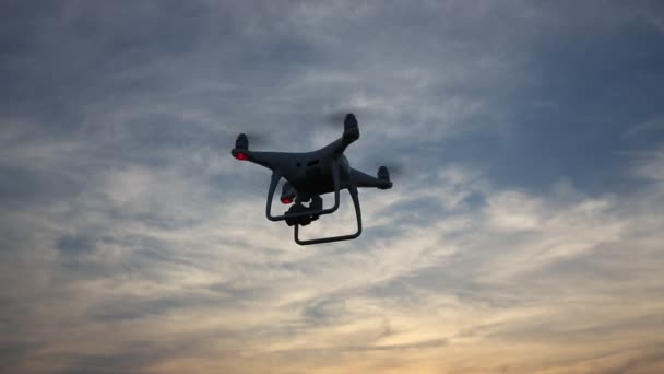 Remote controlled drone with flying in the sunset sky — Stock Video