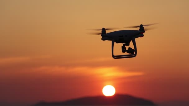 Remote controlled drone flying in air and sunset sky — Stock Video