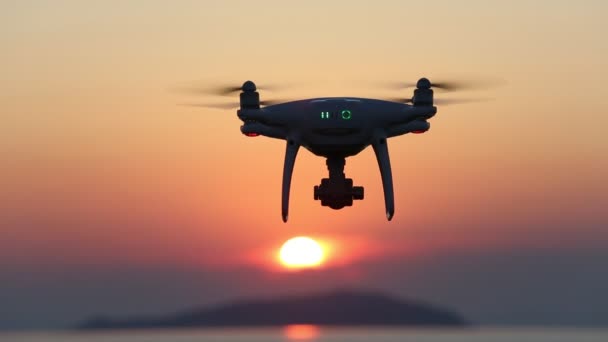 Remote controlled drone flying in air and sunset sky — Stock Video