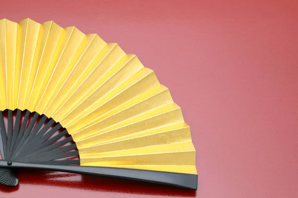 Traditional golden folding fan — Stock Photo, Image