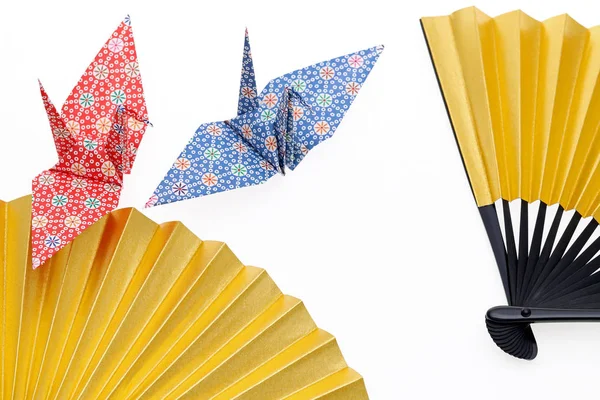 Folding fan and origami bird — Stock Photo, Image