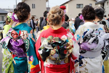 KAGAWA, JAPAN - JANUARY 7, 2018: Young Japanese women wearing traditional kimono for the coming of age day celebration, they turn twenty in Kagawa, Japan.   clipart