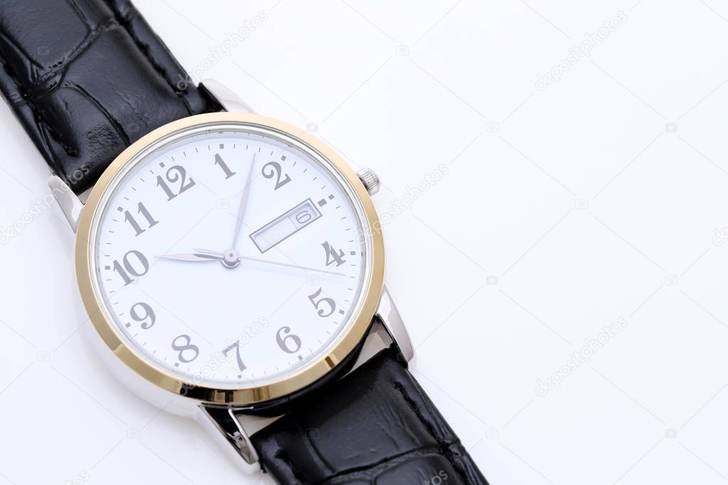 close up of wrist watch with leather strap on white background 