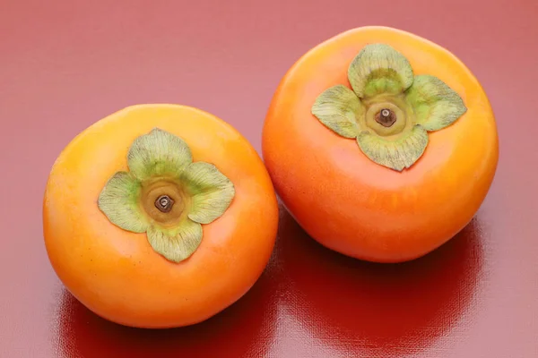 Close Persimmon Fruit Red Background — Stockfoto