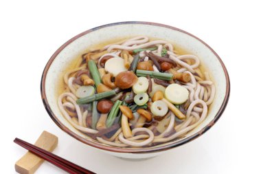 Japanese Sansai soba noodles in a ceramic bowl with chopsticks on white background clipart