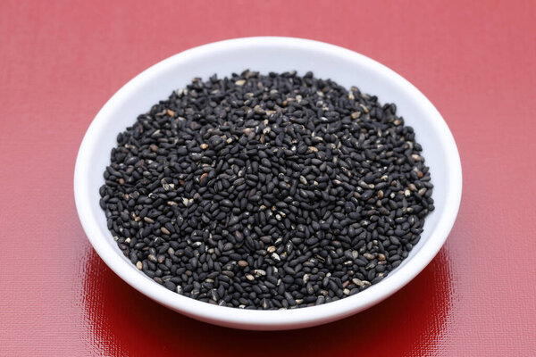 black sesame seeds in a dish on table