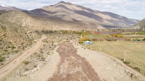 Aerial view of landscape, mountains, valley and horses in Chile