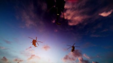Gün batımında uçan askeri helikopter oluşumu