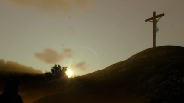 Christian woman praying at Jesus cross at sunset, panning, zoom out — Stock Video