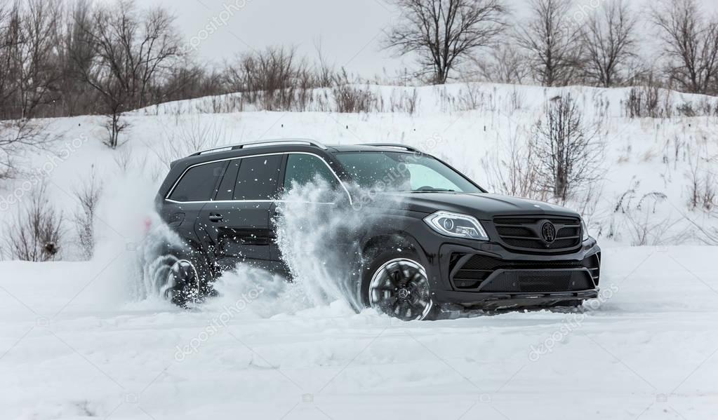 Luxury SUV in deep snow and various weather conditions