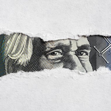 Australian Money Face through Torn Paper