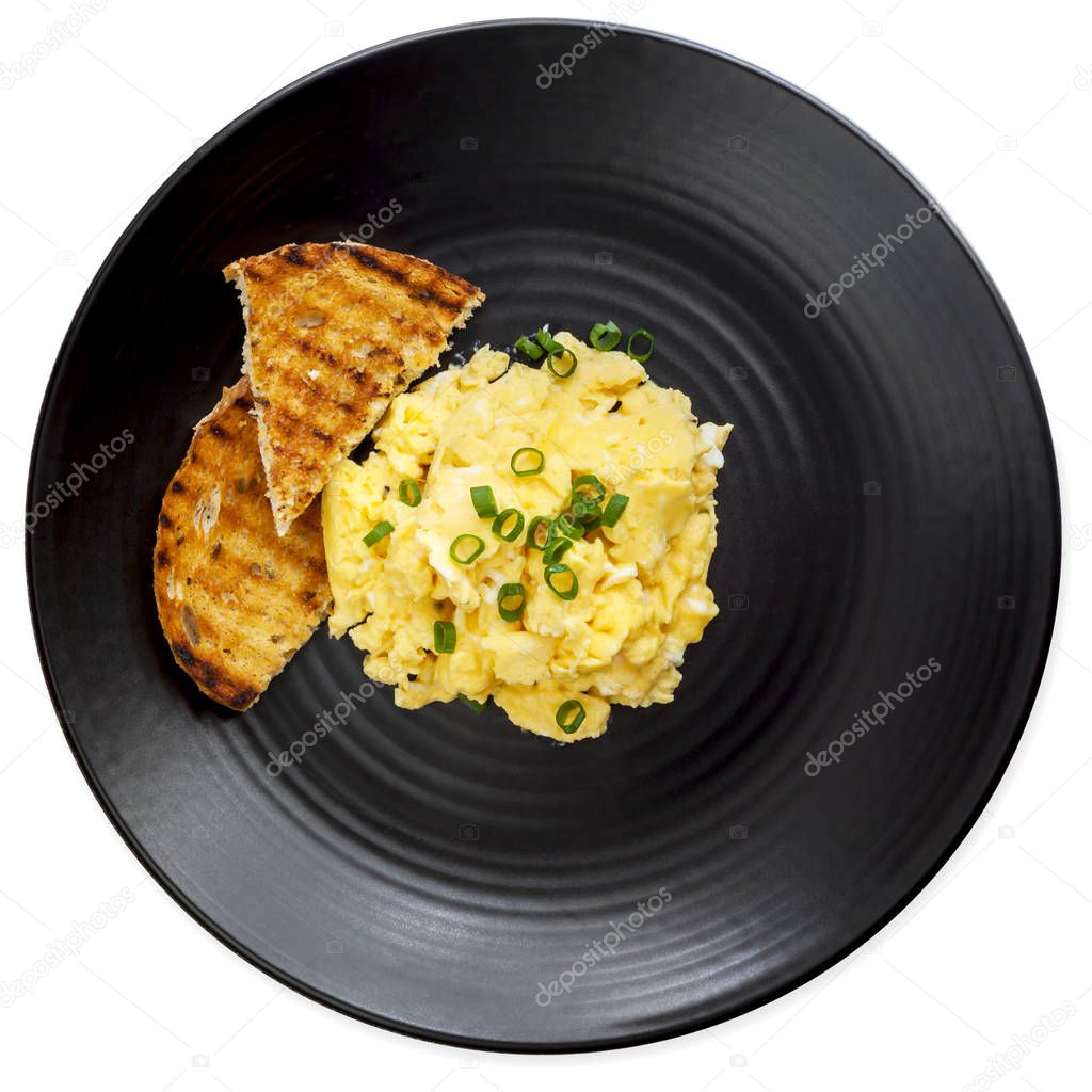 Scrambled Eggs and Toast on Black Plate Top View Isolated on Whi