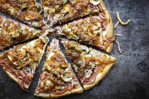 Pizza Sliced Top View on Dark Slate — Stock Photo, Image