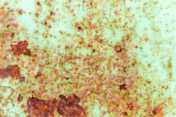 Corroded green metal background.Rusty and scratched metal wall. Painted metal background with rust spots.