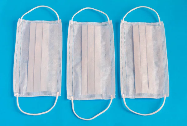 Medical mask.Protective face masks on a blue background.Disposable face mask.Protection against Cavid-19 coronavirus and other infectious diseases.