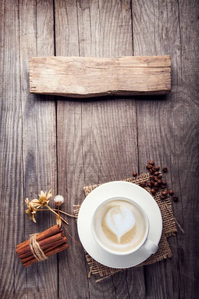 Kopje cappuccino koffie op oude vintage houten tafel, droge bloem — Stockfoto