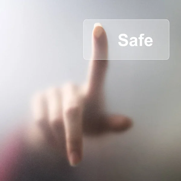 Girl finger presses the button safe on the screen — Stock Photo, Image