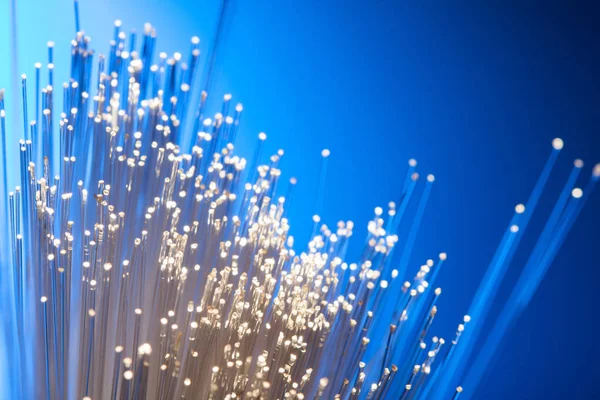 Fiber optics on a blue background, abstract light lines — Stock Photo, Image