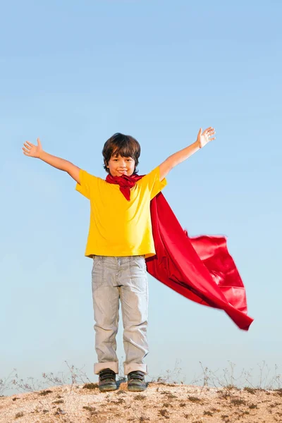 Boy playing superheroes on the sky background, teenage superhero — Stock Photo, Image