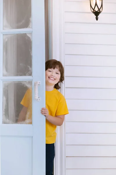 Dítě otevírá dveře domu v obci — Stock fotografie