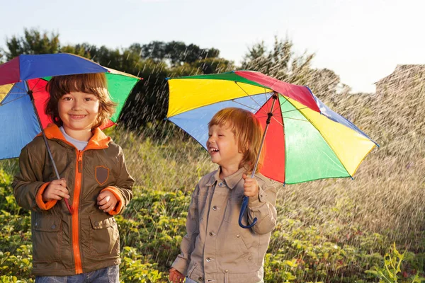 Happy brother with umbrella outdoors — Stock Photo, Image