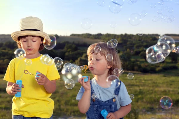 Happy boy play in bubbles outdoors — Stock Photo, Image