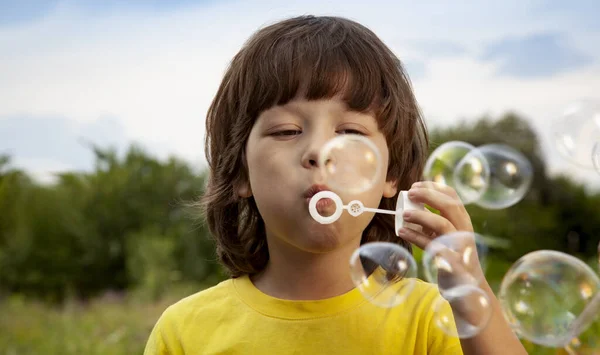 Happy Boy Play Bubbles Outdoors Stock Image