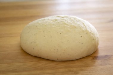 Ahşap masada çiğ bir hamur.