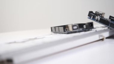 İki Diy tahtası klavyenin üzerine uzanıyor ve düzgün bir şekilde çerçeveye kayıyor. 360 derece dönüş. Efsane laboratuarının atmosferi.