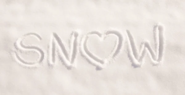 Word snow with a heart, written in pure, fresh snow - concept of loving snowy weather