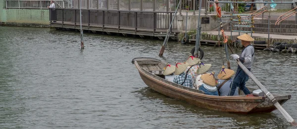 Местные жители и туристы катаются на деревянной лодке на ежегодном фестивале цветов Iris Suigo Itako — стоковое фото