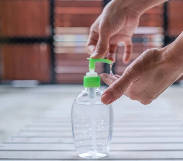 Woman Holding Bottle Water Wooden Table — Stock Photo, Image