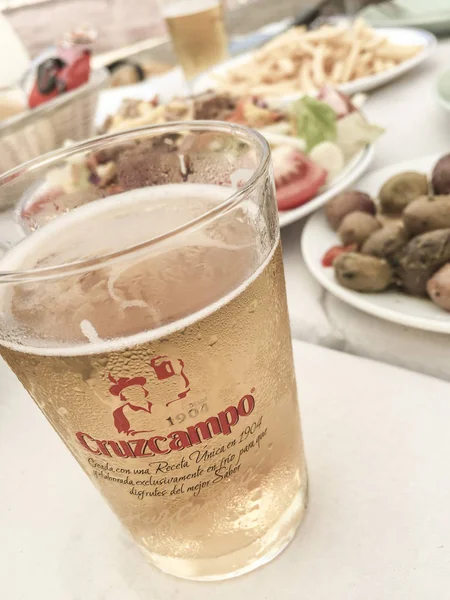 Cruzcampo beer and foods on table in Spain — Stock Photo, Image