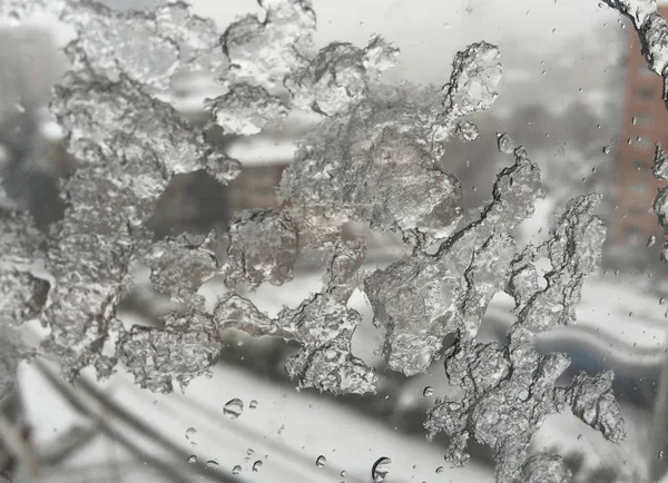 Ice on window against street under snow — Stock Photo, Image