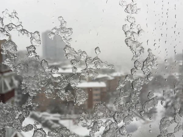 Ice on window against street under snow — Stock Photo, Image