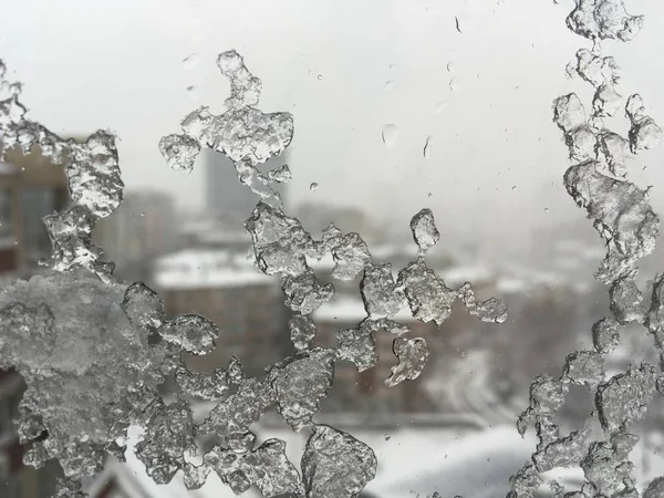 Ice on window against street under snow — Stock Photo, Image