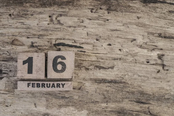 Cube calendar for february on wooden background — Stock Photo, Image