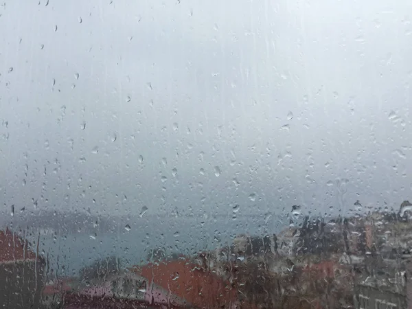 Rain drops on window against buildings in Istanbul, Turkey — Stock Photo, Image