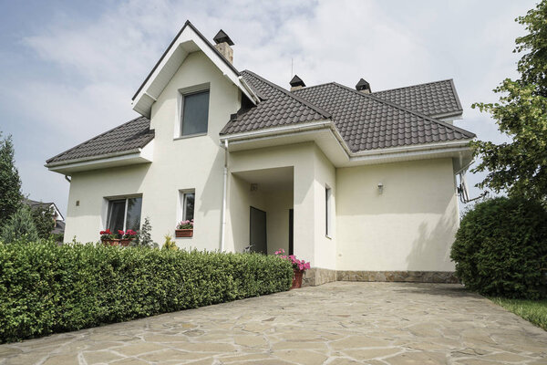 A new house with a garden in a rural area under beautiful sky