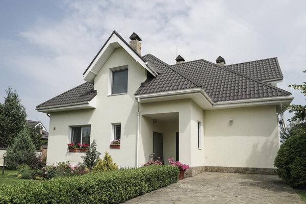 A new house with a garden in a rural area under beautiful sky