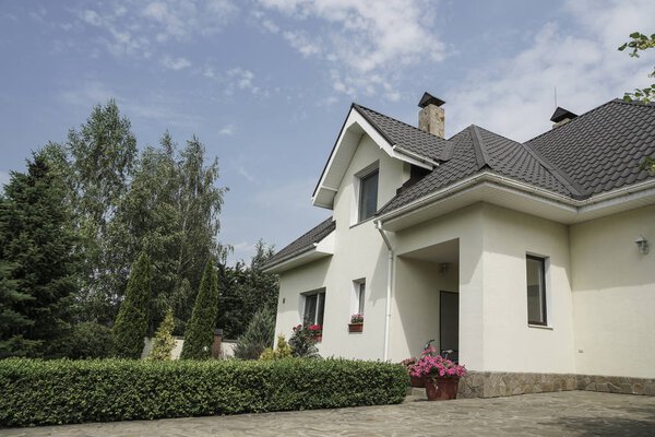 A new house with a garden in a rural area under beautiful sky