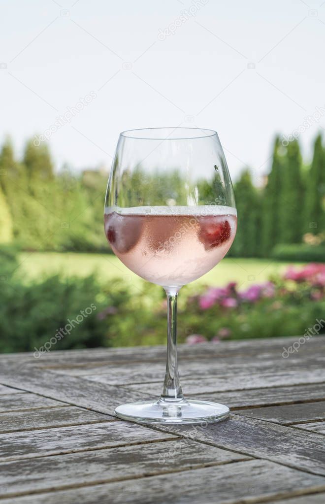 A wine glass on table at garden in summer