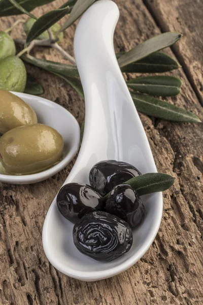 black and green olives on a wooden table