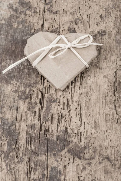 Heart shaped gift on wooden background — Stock Photo, Image