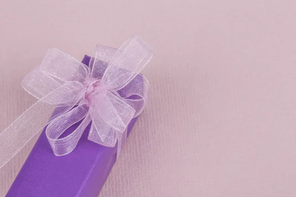 Caja de regalo púrpura con arco rosa — Foto de Stock