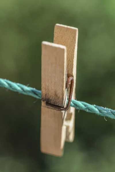 Wooden clothes peg hanged on rope at garden — Stock Photo, Image