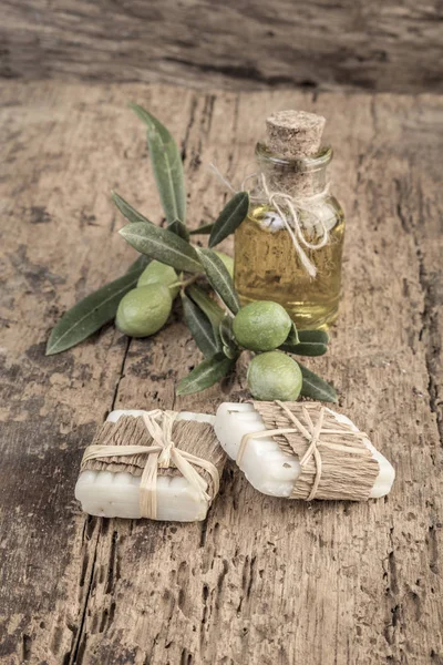 natural olive oil soap bars and oil bottle on wooden table