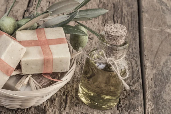 natural olive oil soap bars and olive oil bottle on wooden table